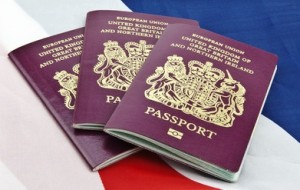 Three United Kingdom passports on folded Union Jack Flag